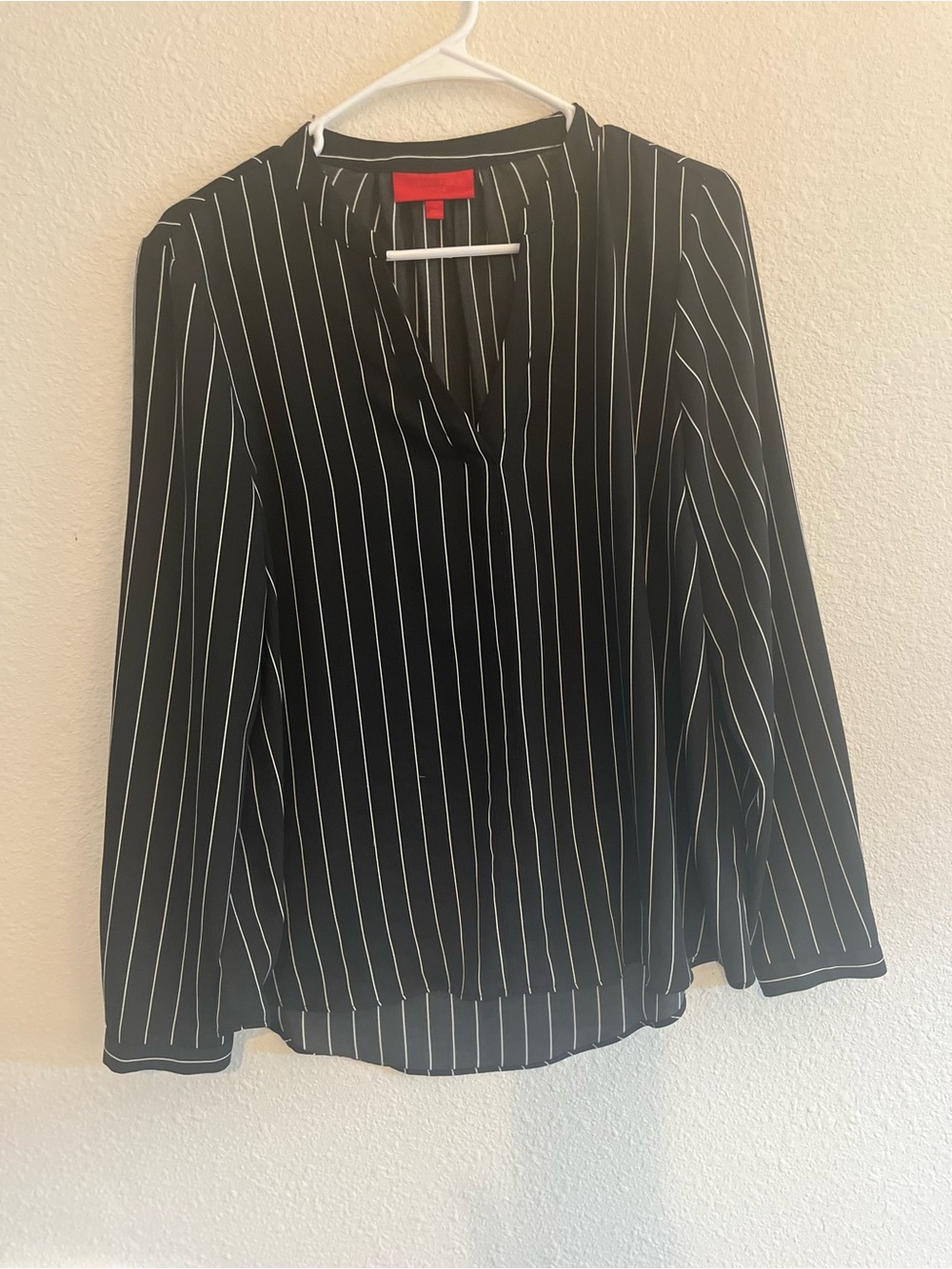 Jennifer Lopez Black Blouse with White Pinstripes